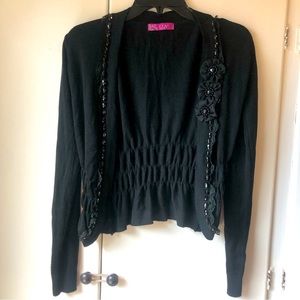 Long sleeved black cardigan with black beading, lace and crepe flower accents